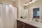 A full-size bathroom with a double sink is a nice addition to the room.